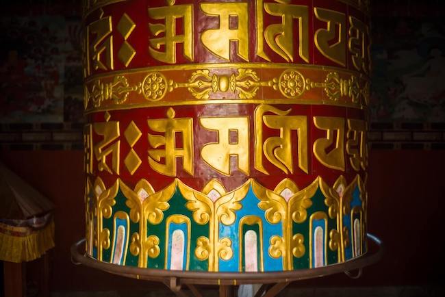 Buddhist prayer wheel having prayer inscribed on it which when spun is equivalent to reciting prayers
